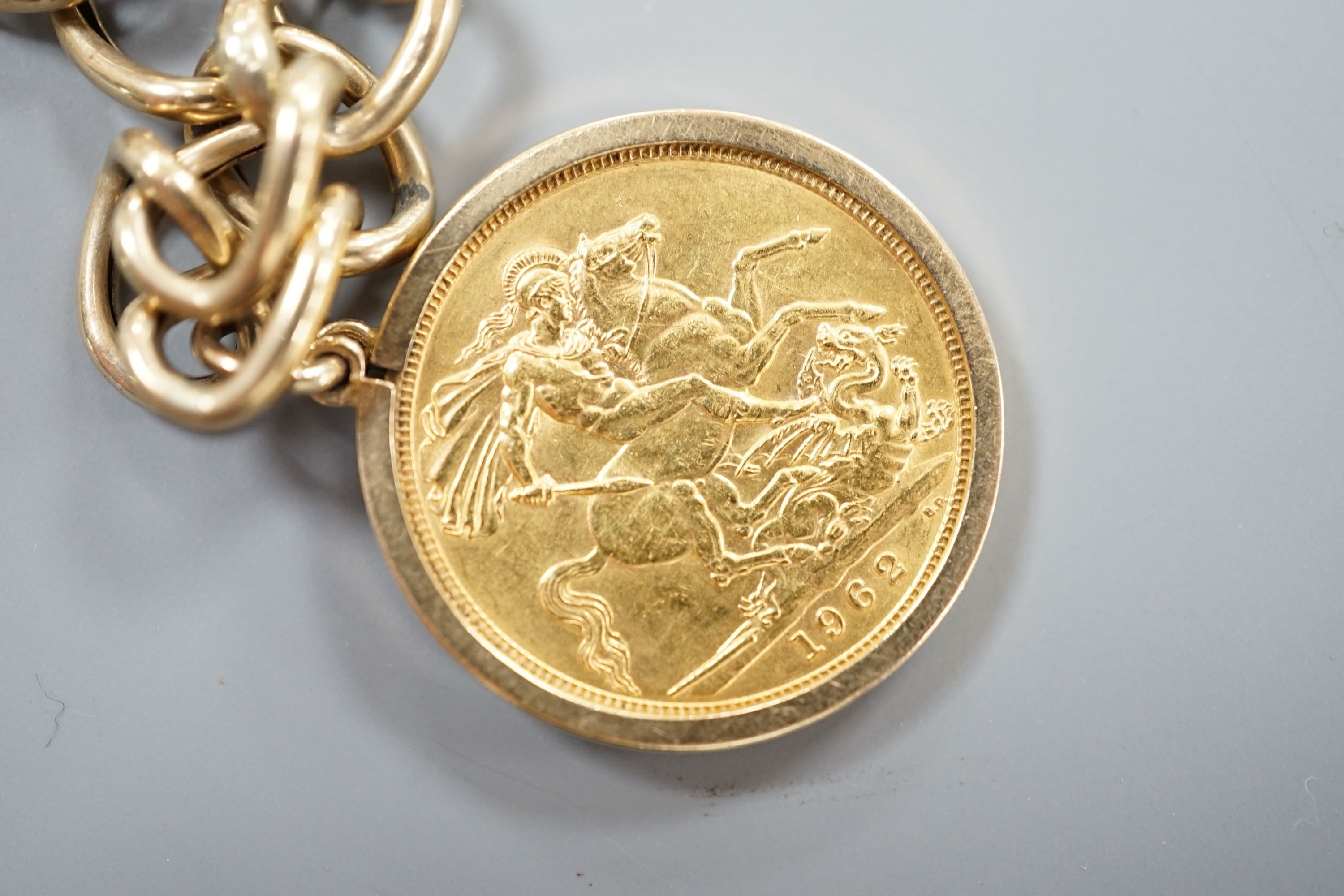 A 1962 gold sovereign, on 9ct bracelet with a 9ct gold gem set ring, gross weight 17.7 grams.